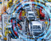 Robotic arms assemble silver car frames on an automated production line in a modern automotive factory, with digital blue concentric circles overlaid.