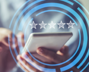 Person using a smartphone with a digital overlay of five stars, suggesting a rating or review concept.