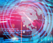 Digital world map overlaid with computer code, abstract data charts, and network lines, illustrating global technology and data connectivity themes.