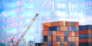 A crane lifts shipping containers at a port, overlaid with stock market numbers and financial charts.
